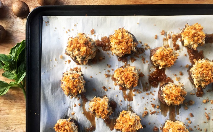 Bake the Chicken Parmesan Stuffed Mushrooms at 400 degrees.